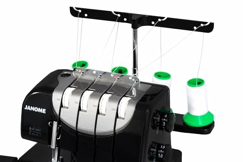 Janome overlock sewing machine with green thread spools.