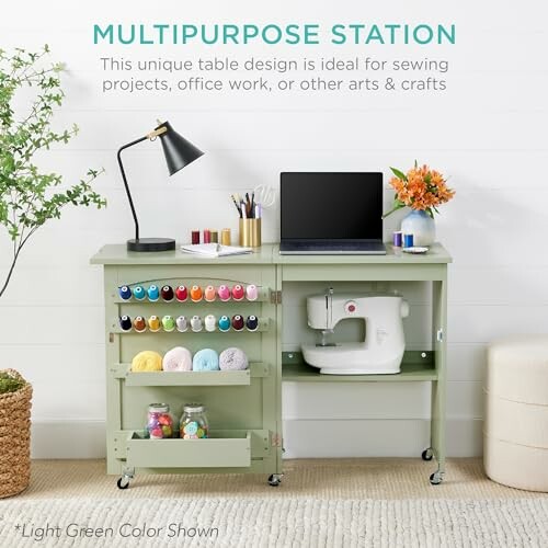 Green multipurpose station with sewing machine, laptop, and craft supplies.