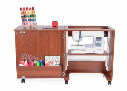 Wooden sewing cabinet with a sewing machine and thread spools