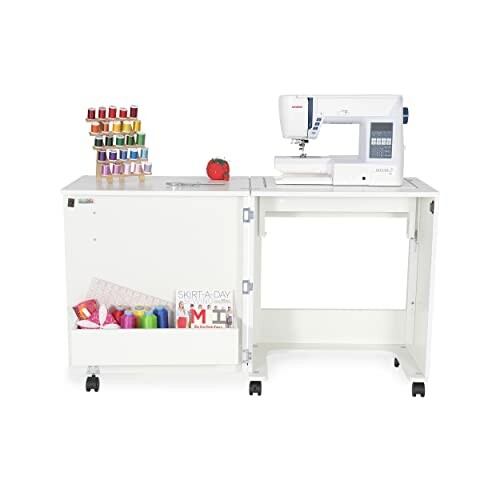 Sewing machine on a white cabinet with thread spools and fabric.