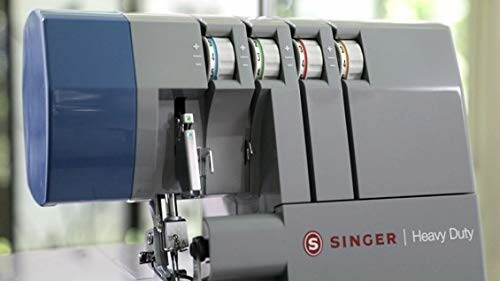 Singer heavy duty sewing machine with multiple thread spools.